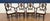 This is a set of four Inlaid Shieldback Arm Chairs by Leighton Hall. The feature shield backs with an inlaid medallion in...