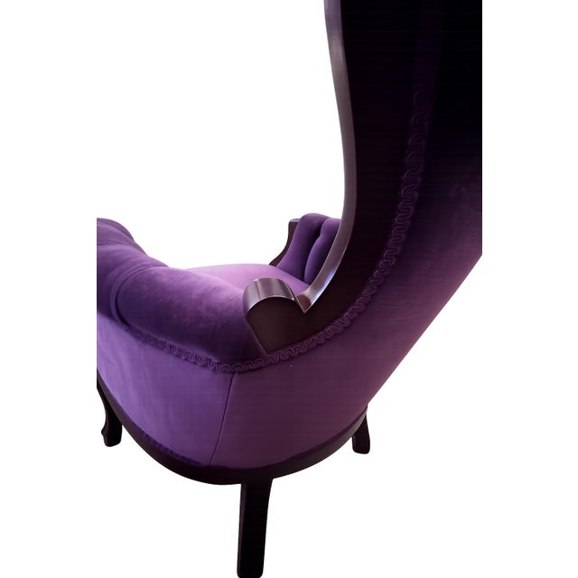 Beautifully crafted Victorian-style lounge chairs featuring dramatic carved wood frames and rich plum velvet upholstery....