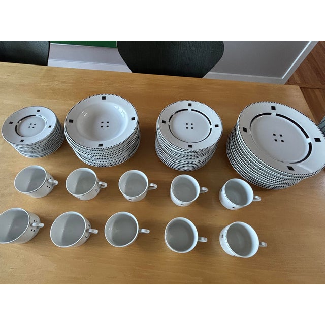 An exceptionally complete 54-piece Swid Powell Tuxedo dinnerware service, offered in near mint condition. Large matching...