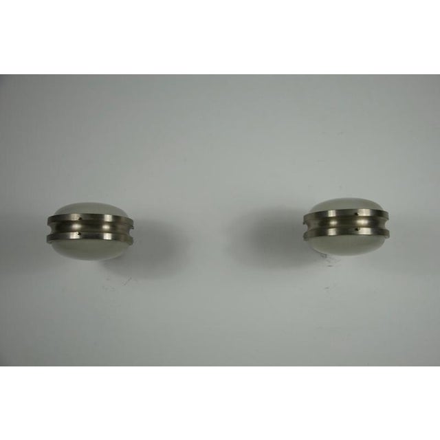 This striking pair of gamma wall lights was designed by sergio mazza for artemide in the 1960s and showcases the refined...