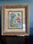 This vibrant piece features a lush jungle scene with a colorful array of tropical parrots, including Macaws. Housed in a...