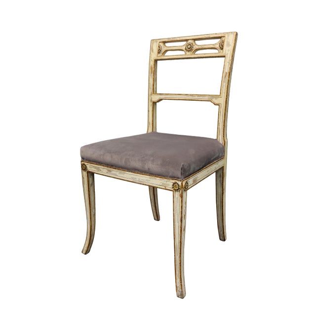 Vintage upholstered chair with antique white distress finish and carved flower medallions on the backs and corners of the...