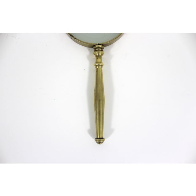 Vintage solid brass magnifying glass. This is quite heavy. The bass, especially around the lens, has some dark spots and...