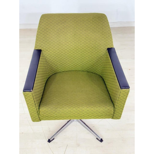 A very nice green vintage armchair from the 1960s with metal swivel legs. The last picture shows the second armchair,...