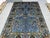 This blue Afghan Sultani wool area rug features a Persian Bijar-inspired design filled with sweeping botanical motifs,...