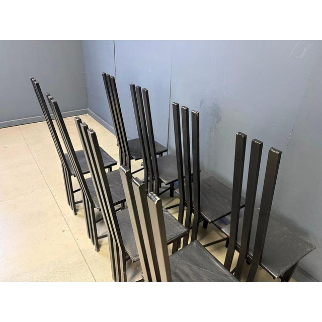 Italian metal postmodern dining chairs with black metal frames and black leather seats. Normal age related wear, we can...