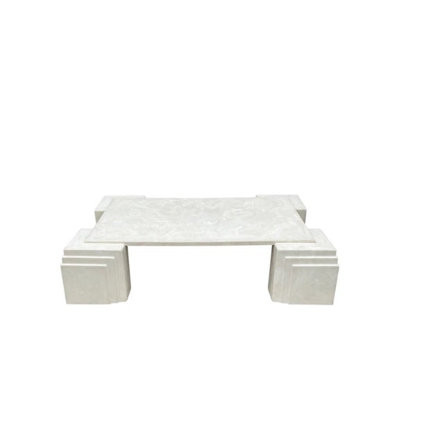 A very large and impressive cocktail table. It features a five piece design with art deco style legs, and very heavy resin...