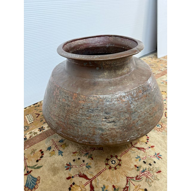 Design Plus Gallery presents a Copper Water Vessel from India. The rounded vessel has a wide rolled rim, raised neck,...