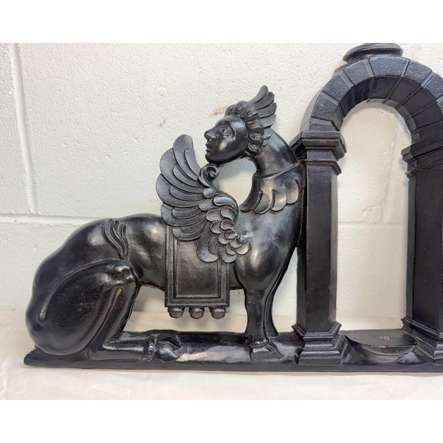 Up for sale is an exquisite antique hand carved wood sculptural pediment from the 19th century. This black-stained...