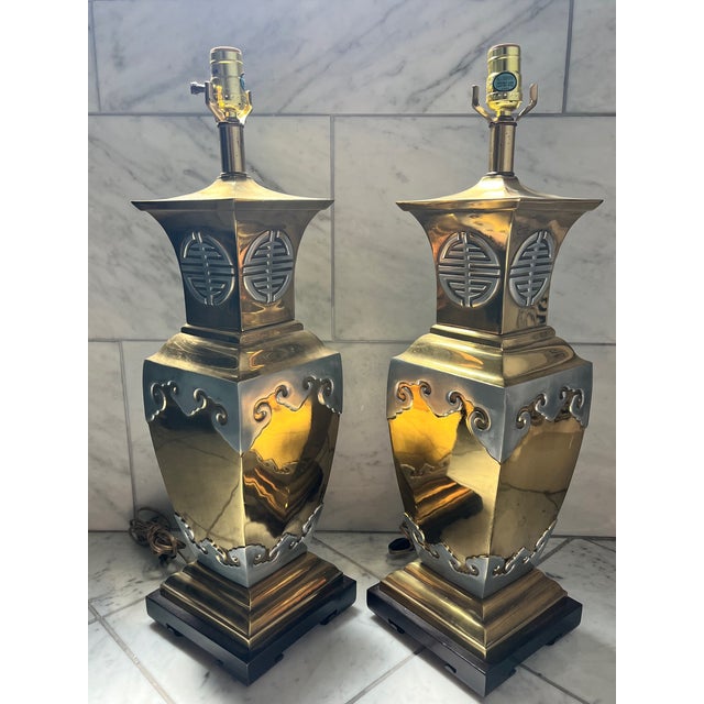 Stunning pair of Chinoiserie brass table lamps with chrome accents. In the style of James Month with beautiful scrolling...