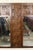 Large wall mirror with mosaic wood carved pattern. A "T" shaped design that splits the mirror in half. Warm walnut wood...