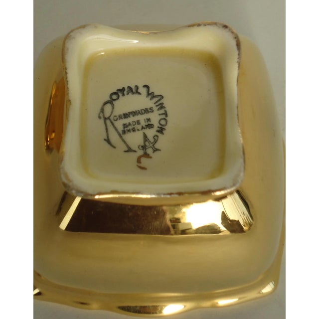 A vintage Royal Winton Grimwades gold creamer and sugar set. The gold finish has a moderate amount of light wear, some...