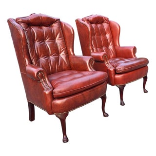 Pair of Classic Leather Furniture Tufted Oxblood Leather Wingback Library Lounge Chairs With Brass Nailhead Trim, Circa 1980s For Sale