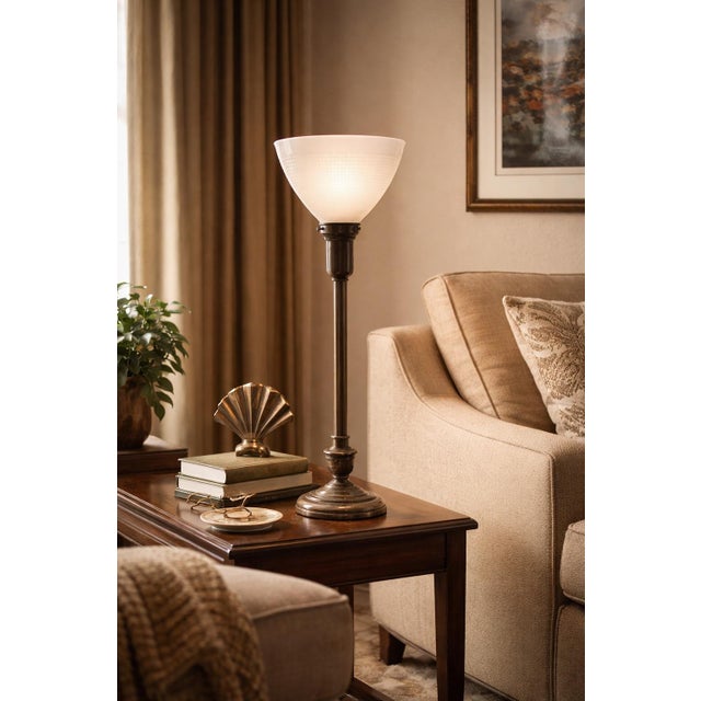 An early 20th century Mitchell Manufacturing Co. Model M117 torchiere table lamp featuring a richly patinated metal base...