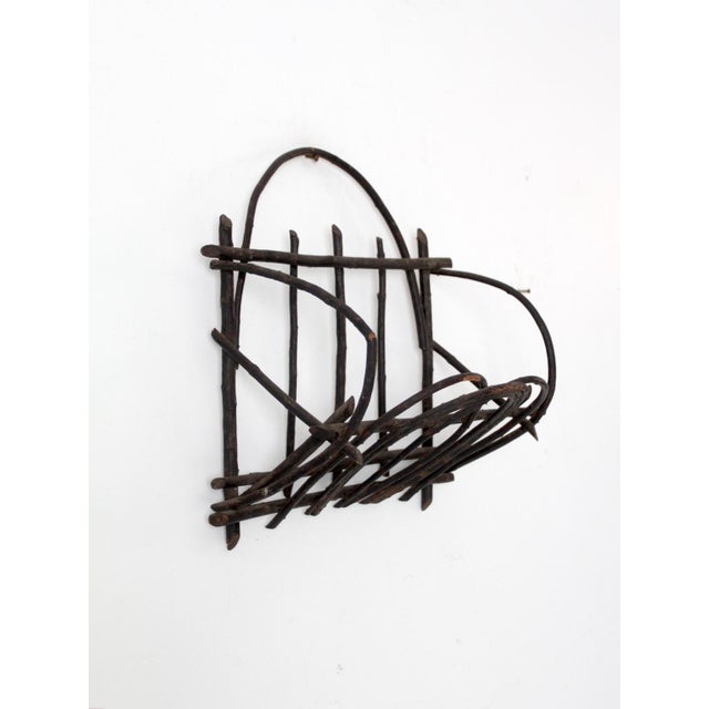 This is an antique Adirondack style twig wall basket. Crafted from willow branches, the black basket features a horseshoe...