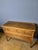 A Louis XVI period commode in solid walnut with brass stringing. It features two drawers in the front, separated by rails,...