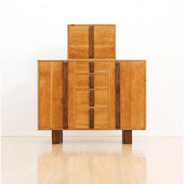 A fantastic oak buffet cabinet made in England circa 1950s. Blending Art Deco and Brutalist design elements this striking...