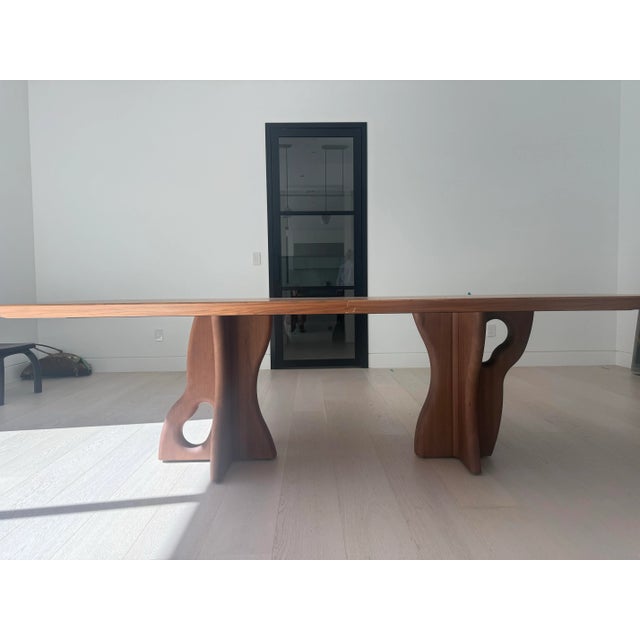 Suma dining room table by Uultis Studio with walnut veneered top measuring 110 inches and organic solid wood legs. Please...