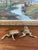 This pair of vintage brass toned frog sculptures features a charming and lifelike representation of crouching frogs,...
