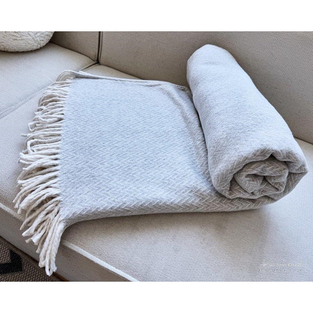 The “Marina Throw Jacquard” from Arlene Angard Designs and Fine Arts, a soft, high-quality throw made from recycled...
