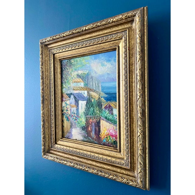 Hand-painted vintage oil painting depicting a charming Mediterranean coastal village overlooking the sea. The colorful...