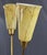 A charming three-arm floor lamp from the 1960s–70s featuring brass arched stems and yellow marbled glass shades. The round...