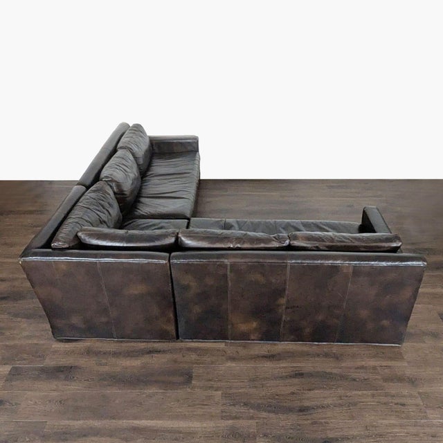 This Restoration Hardware sectional features durable dark brown leather and deep, comfortable cushions. Its L-shape design...