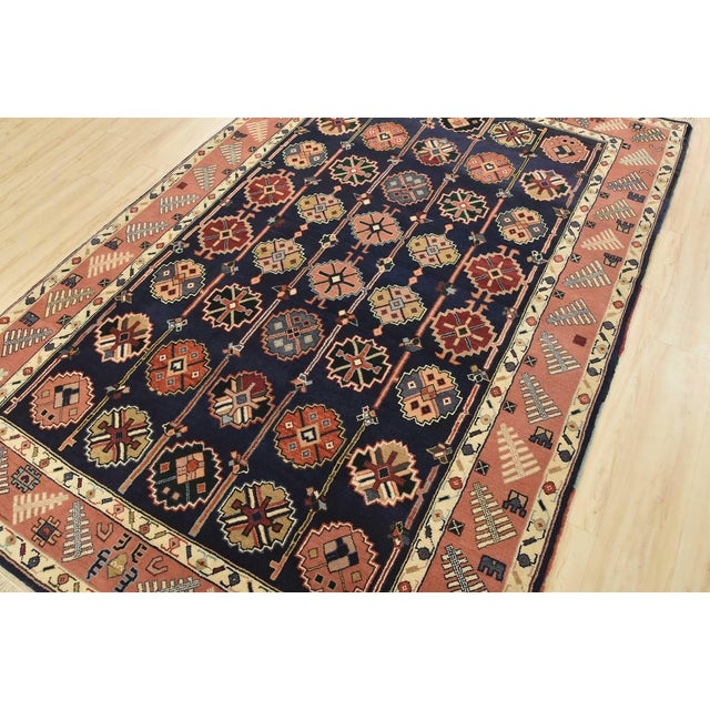 An authentic vintage tribal Heriz rug hand-knotted with fine wool on a cotton foundation. This rug features rows of...