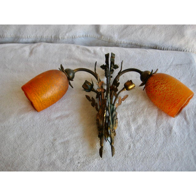 A pair of gilt metallic sconces in the shape of roses with glass shade , lovely for sure the details in on the leaves and...