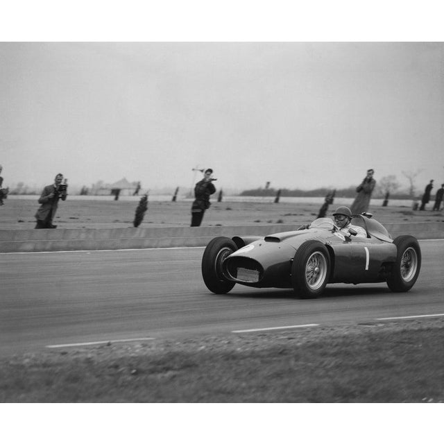 Juan Manuel Fangio Argentinian racing driver Juan Manuel Fangio in a Ferrari at Silverstone racetrack. (Photo by Evening...