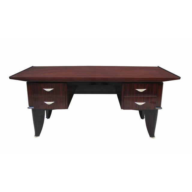 An important Art Deco desk. Designed by Sanyas et Popot, Paris. Macassar with original patinated bronze pulls and sabots....