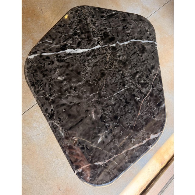 Elevate your space with this sophisticated contemporary end table, featuring a striking black marble top with dramatic...