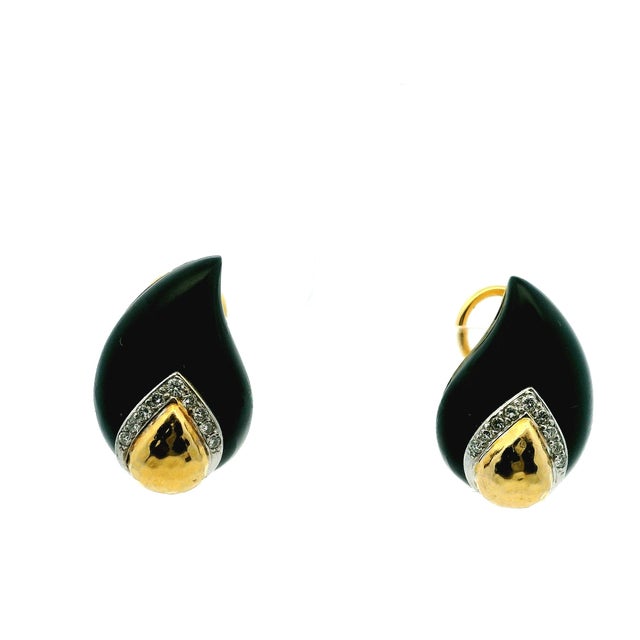 Striking vintage MAZ earrings crafted in 14K yellow gold, featuring sculptural black onyx forms accented with diamond-set...