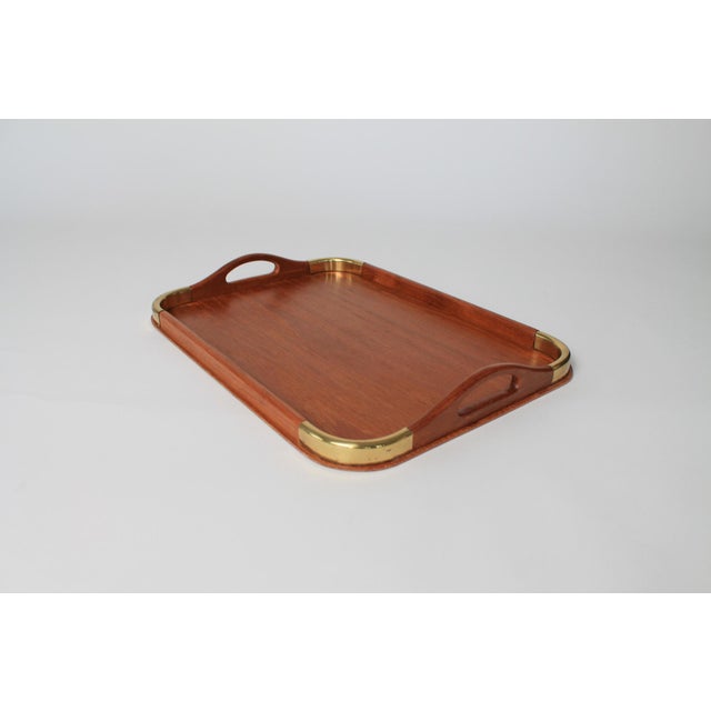 Vintage genuine teakwood serving tray with brass accents. Makers mark on the bottom. Made in Thailand. Some light age wear.