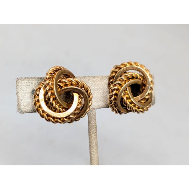 Goldtone smooth and rope textured loopy "knot" clip earrings. Marked "19 GROSSE© 69 GERMANY" on the bases of the clips....
