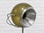 Vintage Mid Century Modern RAAK floor lamp featuring an olive-green spherical shade, a silver-tone reflector, and a...