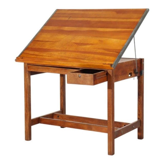 An authentic antique Arts & Crafts period drafting table, crafted from solid oak, dating to approximately 1930. This piece...