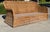 A striking vintage woven rattan lounge sofa featuring a dramatic curved silhouette and oversized braided trim. Its...