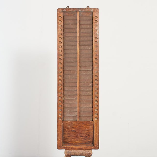 A beautiful oak factory workers clocking in and out holder. This would have been used in a factory to log the employees...