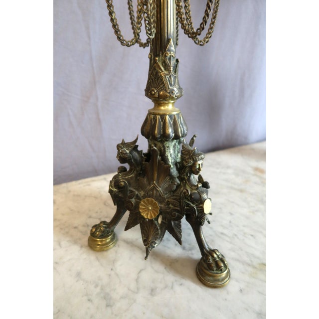Pair of large bronze candelabra in the style of Barbedienne. These six-light candelabra rest on a tripod base with female...