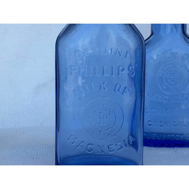 Two wonderful PHILLIPS MILK OF MAGNESIA blue glass bottles from approximately 1930's - 1960's.