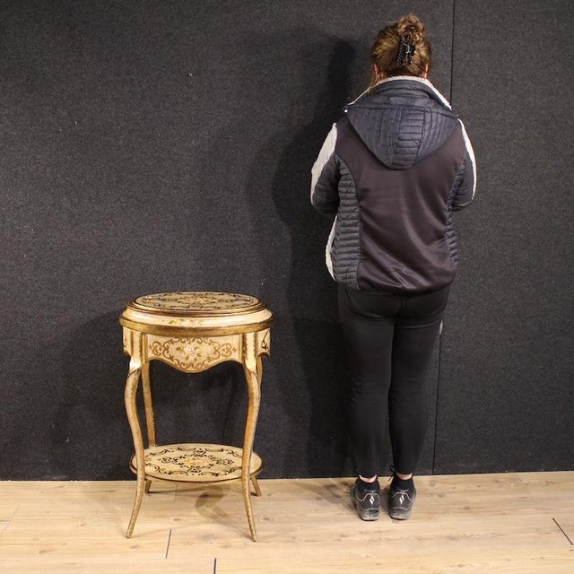 Mid-20th-century Italian side table. Tuscan-style piece of furniture made of finely carved, lacquered, gilded, and hand-...