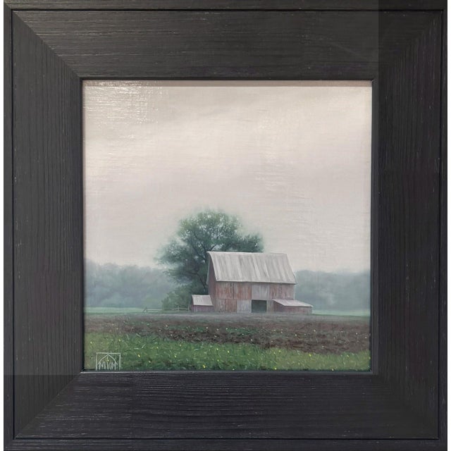 This oil on panel depicts a solitary barn set against a moody, rain-soaked landscape, enveloped in soft, muted tones. The...