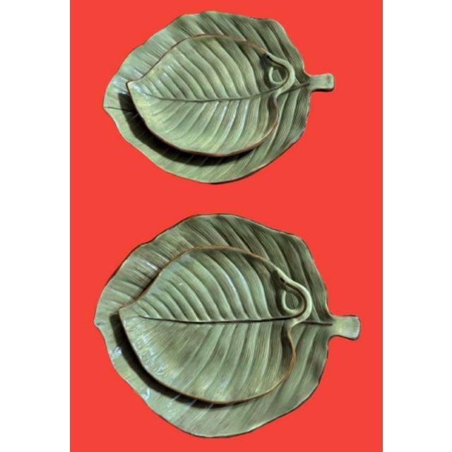 A beautiful set of ceramic platters in the shape of tropical leaves green with a touch of brown. 2 large plates 14” x...