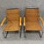 Pair of Chairs in the Manner of Marcel Breuer. Featuring a steel frame and woven wicker armchairs, these chairs combine...