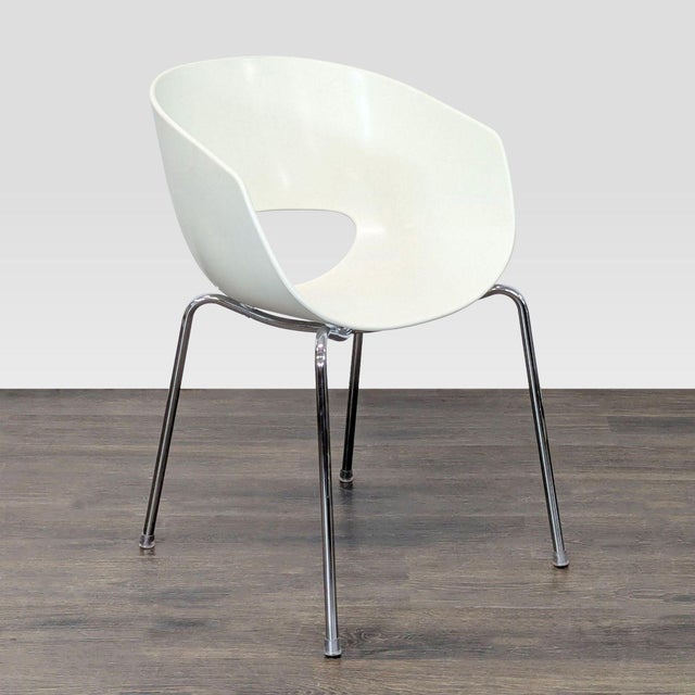 The Orbit chair was designed and manufactured in Italy circa 1970s. This minimalistic chair features a white resin plastic...