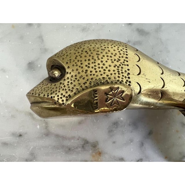 Antique brass dolphin door knocker featuring Maltese Cross