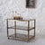 Gold-colored steel and smoked glass serving trolley with wheels for easy movement. The sliding central tray makes it ideal...