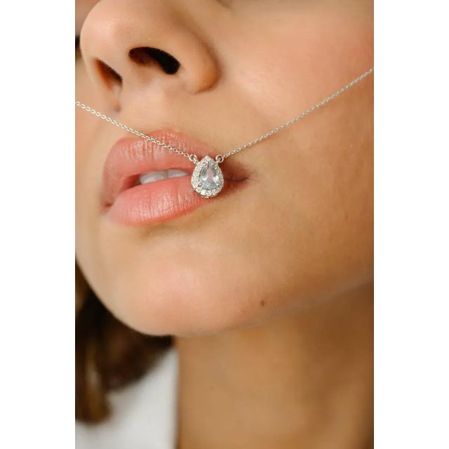 This is part of Chairish’s Fine Jewelry assortment. Pear Aquamarine Halo Diamond Chain Necklace in 14K Gold studded with...