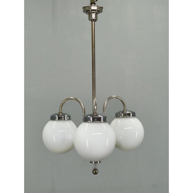 Exceptional art deco chandelier produced in czechoslovakia during the 1930s. This elegant fixture combines a chrome-plated...
